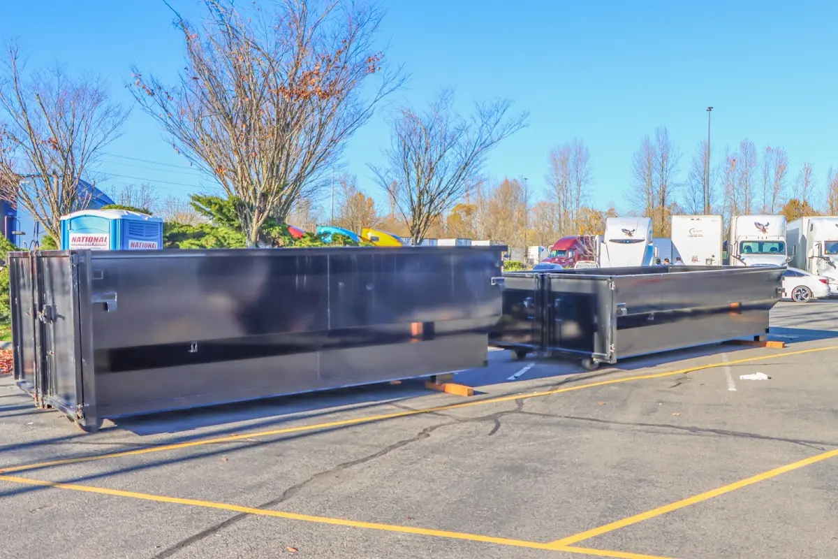 Professional dumpster rental service with roll-off container on residential driveway in Lakeway